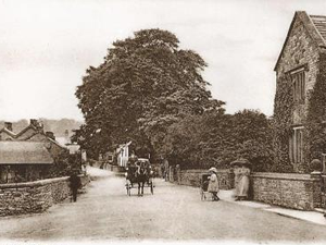 View Youlgreave in the 19th century - a postcard showing the Old Hall (right) and stables (left)